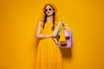 smiling woman with multicolored bags posing isolated background