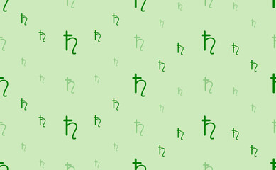 Seamless pattern of large and small green astrological saturn symbols. The elements are arranged in a wavy. Vector illustration on light green background