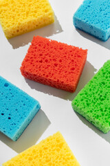 Pattern with colorful sponges for dishwashing on white background