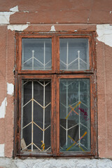 Old broken window in a wooden frame.