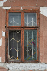 Old broken window in a wooden frame.