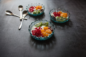 Close up of popular dessert item fruit salad served in a bowl on a background.