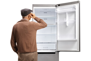 Rear view shot of an elderly man standing in front of an empty fridge