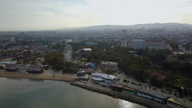 The resort of the Black Sea coast city of Anapa, Russia. The central city beach in the autumn. Top view from the sea. 4k drone video