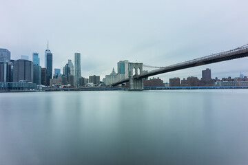 Panoramic view of New York City in Manhattan at sunrise with skyscrapers and Brooklyn Bridge