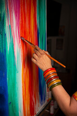 Woman's hand with bangles painting 