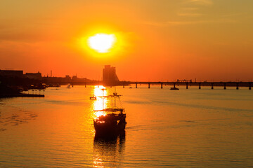 Fototapeta na wymiar Tourist ship sailing on the Dnieper river at sunset in Dnipro, Ukraine