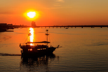 Tourist ship sailing on the Dnieper river at sunset in Dnipro, Ukraine