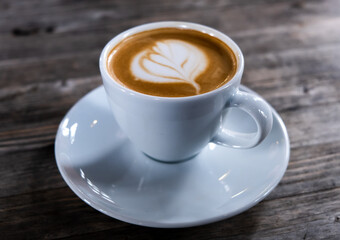 Close up of hot latte coffee in the cafe, latte art coffee. 