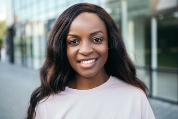 Close up portrait beautiful african american pretty woman with dark hair posing smiling white teeth...