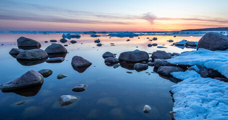 spring ice on the rocky seashore