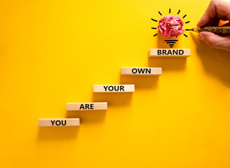 You are your own brand symbol. Wooden blocks with words You are your own brand. Beautiful yellow...
