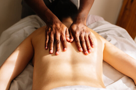 Hands of african american professional therapist giving a massage