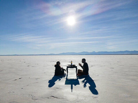 Two friends having a meal in the desert