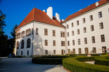 Fototapeta na wymiar Trebon, South Bohemia, Czech Republic, 9 October 2021: Castle Courtyard, Renaissance chateau with tower and sgraffito mural decorated plaster at facade at sunny day, medieval historical town with park