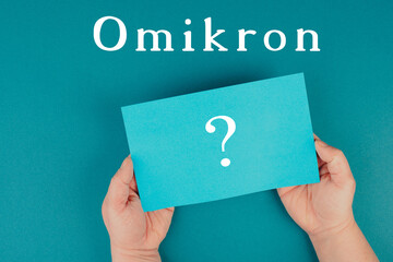 The german word for omicron is standing on a paper, new covid-19 variant from south africa, pandemic