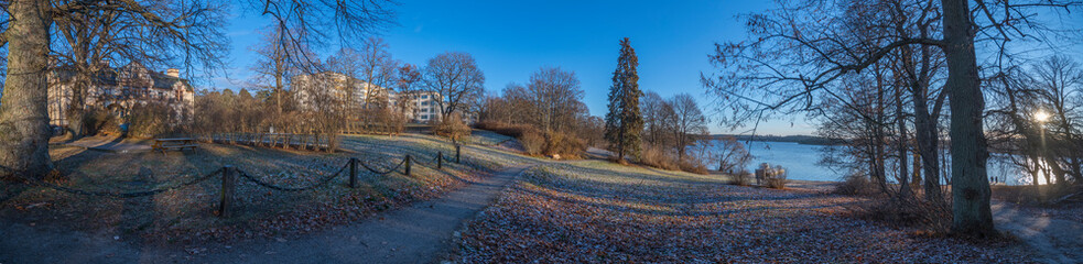 Panorama view of apartment buildings and a castle at the lake Mälaren in the district Blackeberg in Bromma a sunny autumn day in Stockholm
