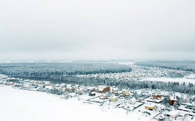 Aerial view of the winter landscape. White fields of suburban villages