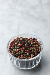 Pile of pepper seeds in a bowl. Vertical