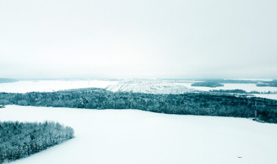 Aerial view of the winter landscape. White fields and meadows of nature