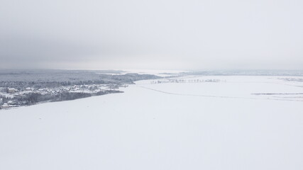 Obraz premium Aerial view of the winter landscape. White fields and meadows of nature