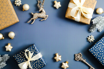 Blue Christmas background with Christmas decorations, gift boxes, baubles, stars. Flat lay, top...