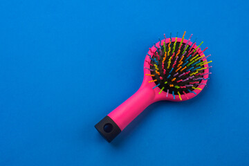 multi-colored children's comb on a blue background