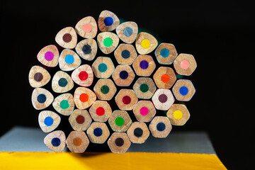 A set of colored pencils lying horizontally