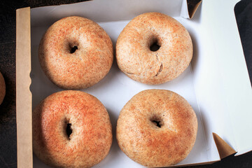 Healthy organic whole grain bagels in a box. Top view, Selective focus.
