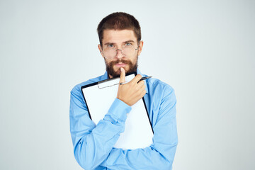 bearded man in blue shirt documents manager professional