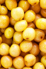 Lots of ripe cherries with stems and leaves. Large collection of fresh cherries. Ripe cherries background. Cherry. Yellow cherry