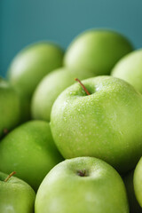 Organic juicy Green apples on a green background.