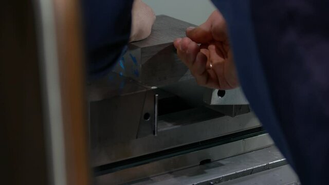 Worker is installing metal block in a locksmith vice.