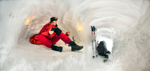 Climber in a snow cave. - obrazy, fototapety, plakaty