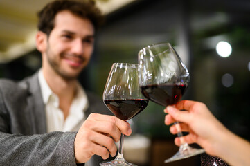 Couple toasting wineglasses in a luxury restaurant