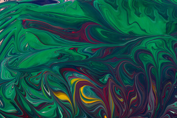 Beautiful liquid texture of the nail polish.Green and purple colors.Multicolored background with copy space.Fluid art,pour painting technique.Good as digital decor.