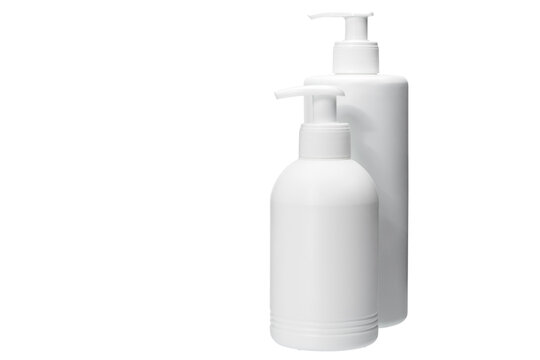 two several size matte opaque white plastic bottle with dispenser for portion use of liquid soap for hygiene and skin care, isolated object on white background with copy space, nobody.
