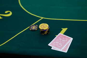 Poker cloth, deck of cards, poker hand and chips. Background. Poker game concept on green table. Cards lying on the green table, poker and blackjack games. Casino game chips with copy space.