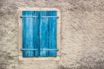 Window with closed blue wooden shutters