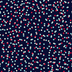 Seamless repeating spotted pattern with tiny colorful hand drawn confetti-like dots. Christmas night, New Year eve concept. Dark vector background for wrapping paper, other design projects