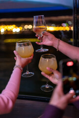 Drinks in a nightclub, friends enjoying a party with their glasses up, shout with orange and gin tonic