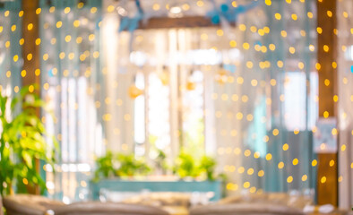 Blurred holiday background. Bokeh background of Christmas garlands. Beautiful New Year's home interior decorations.