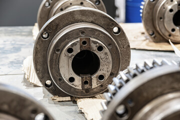 Disassembled spindles of cnc machines for repair in a metalworking equipment repair workshop.