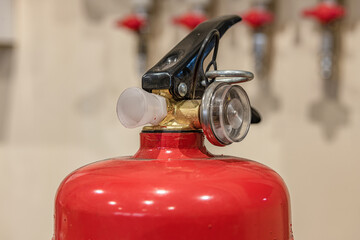 Small hand-held fire extinguisher with pressure gauge in a locksmith's shop.