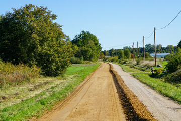 gravel road leveling in rural areas with the help of a grader