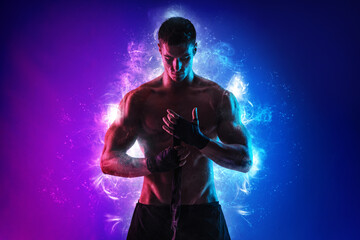 Boxing concept. Sportsman muay thai boxer fighting in gloves. Isolated on neon background. Copy...