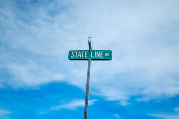 State Line Rd sign with sky background