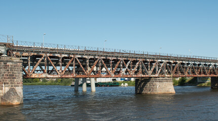 Fototapeta na wymiar Iron old bridge over the river