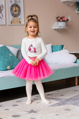 Cute little girl posing in a costume in her room