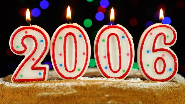 Birthday cake with white burning candles in the form of number 2006